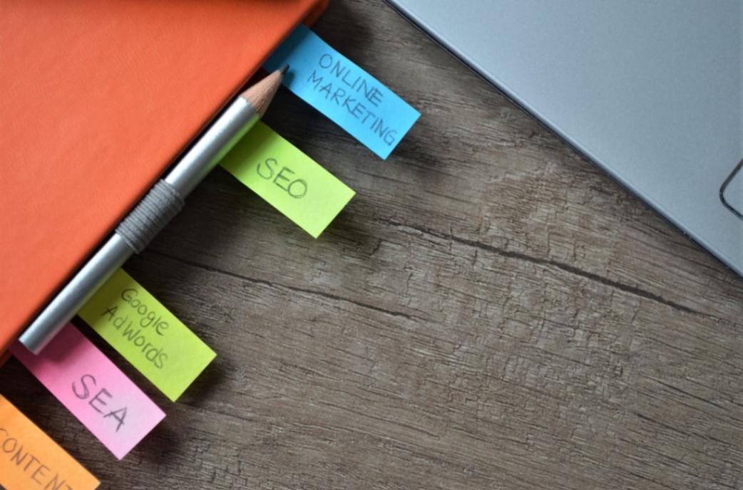 A close-up of sticky notes and a pencil on a notebook, symbolizing planning and strategy for improving SEO rankings and website optimization.